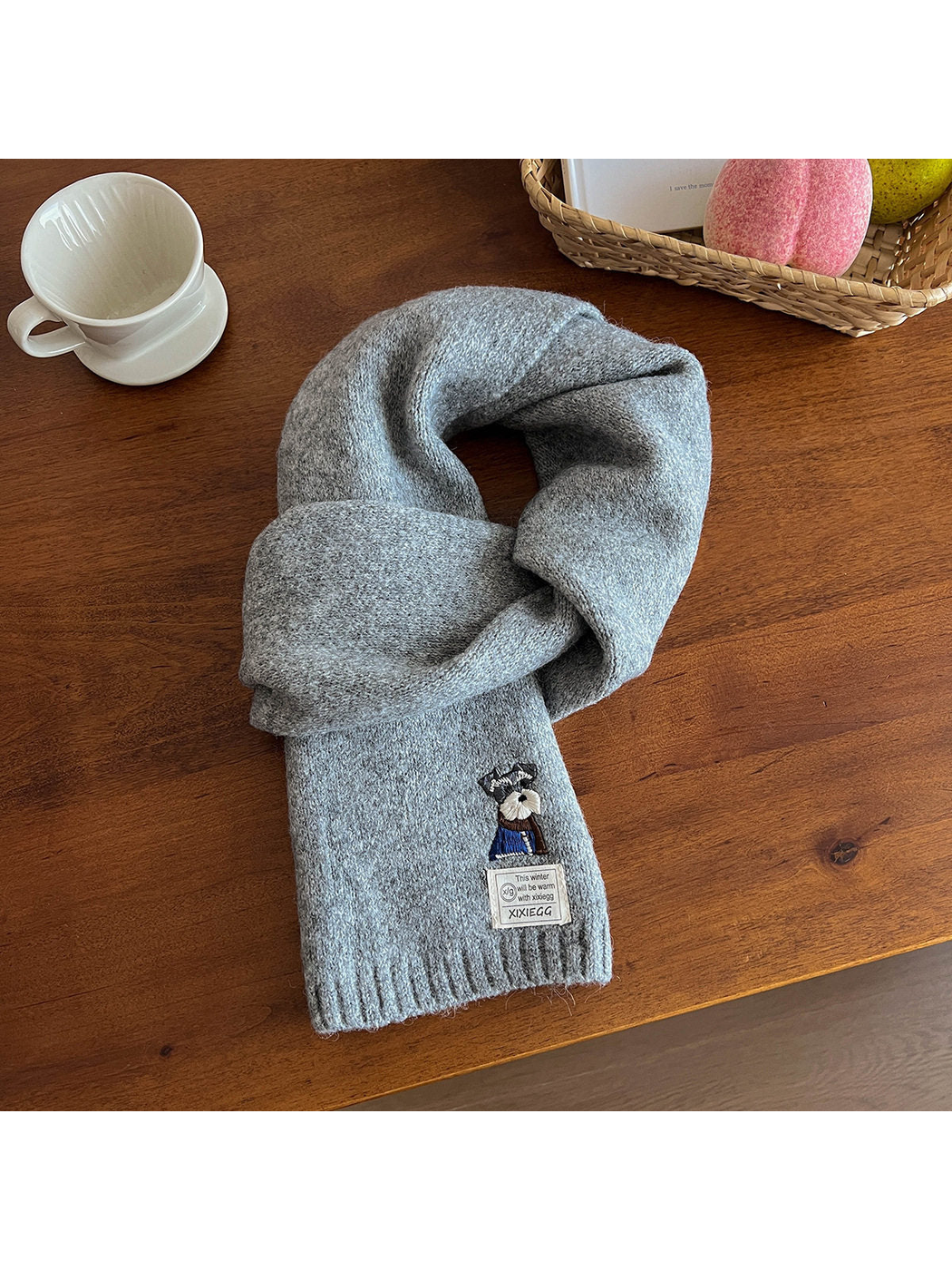 Light gray fuzzy scarf with embroidered dog motif and ribbed end
