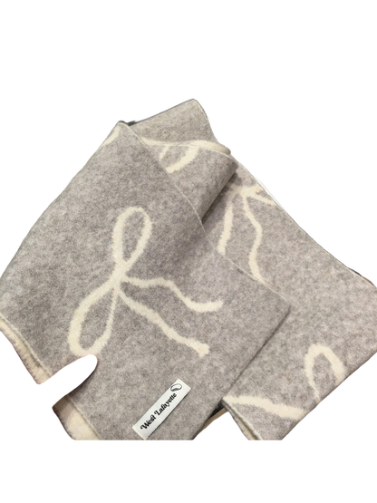 Close-up of the gray brushed scarf with contrasting bow motifs
