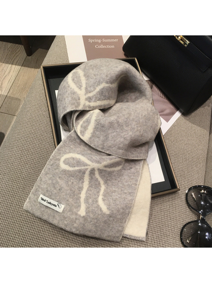 Light gray scarf with cream bow motifs, draped view
