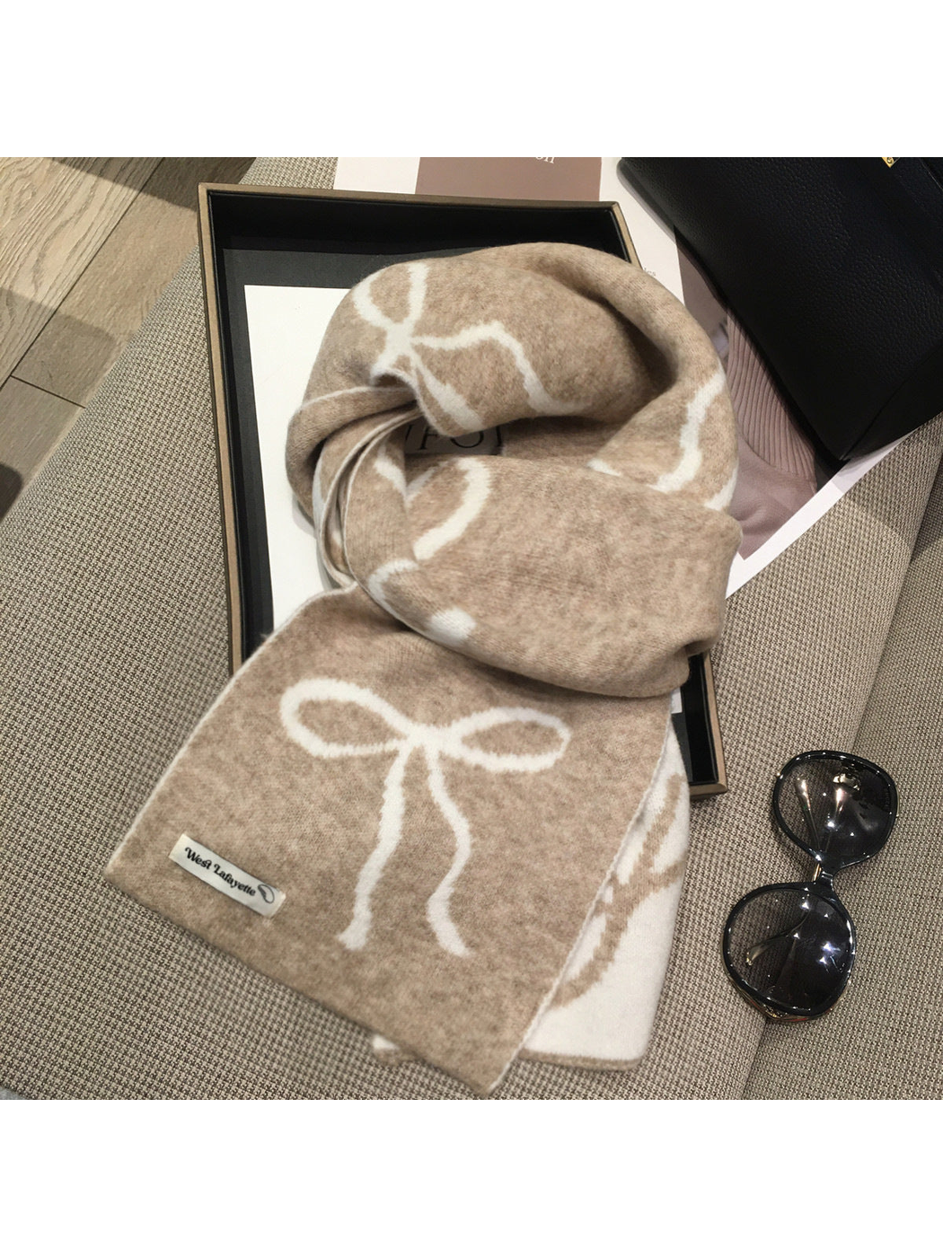 Beige scarf with cream bow motifs, draped view