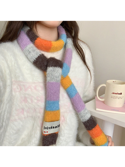 Orange, brown, lavender and blue fuzzy color-block scarf worn in a front knot