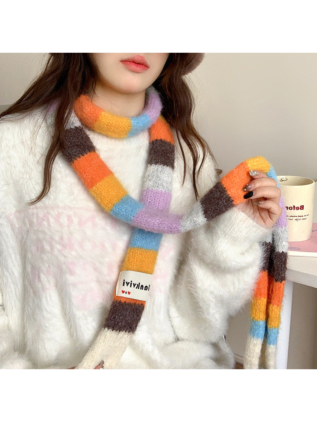 Orange, brown, lavender and blue fuzzy color-block scarf worn looped at the neck