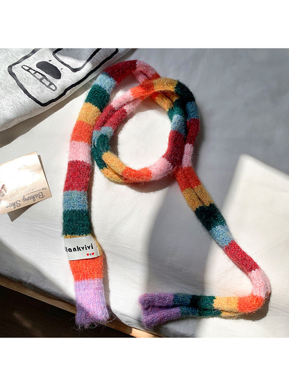 Red, pink, green and orange fuzzy color-block scarf arranged in a long loop