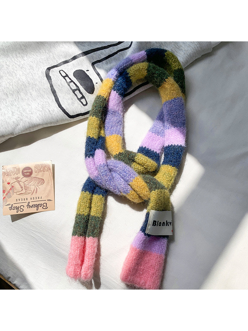 Pink, lavender, olive and navy fuzzy color-block scarf arranged in a loose knot