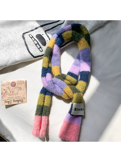 Pink, lavender, olive and navy fuzzy color-block scarf arranged in a loose knot