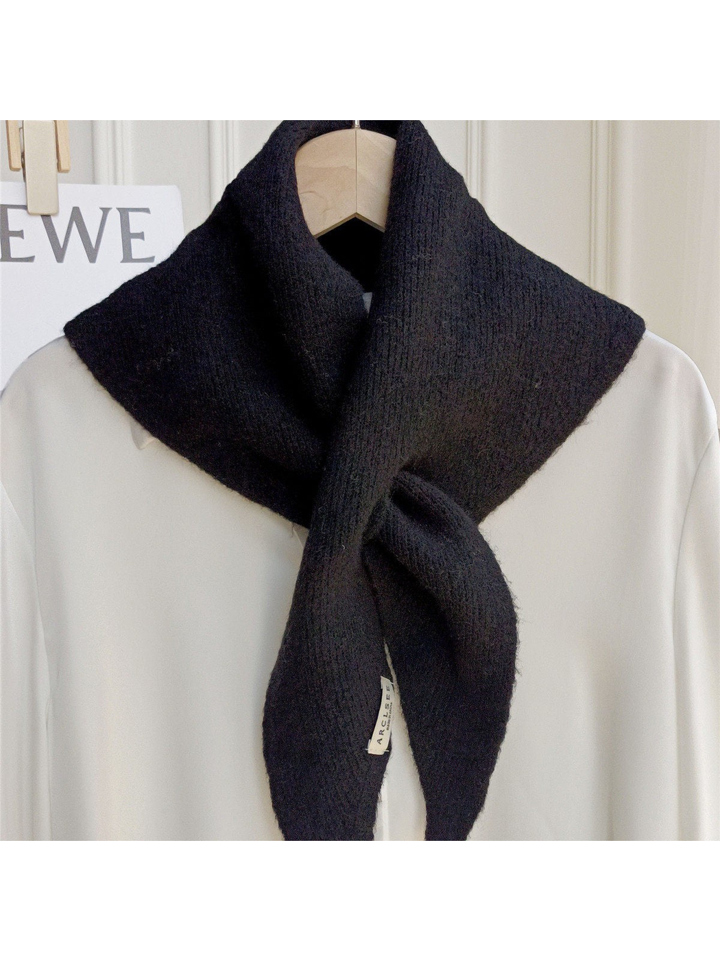 Black pull-through scarf with tapered ends, front view
