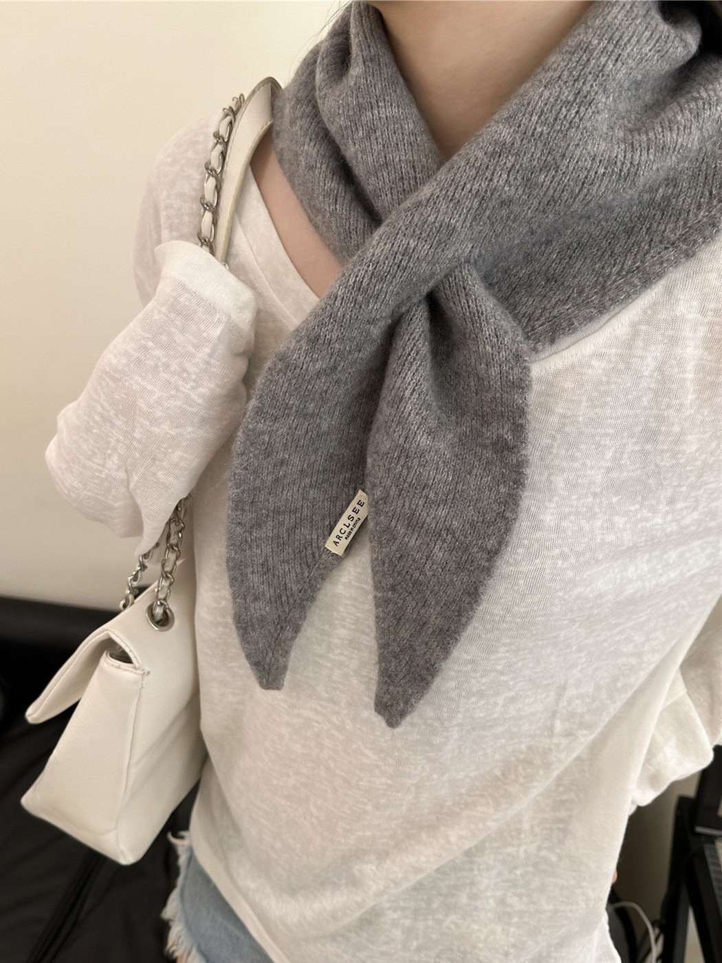 Gray pull-through scarf with tapered ends, worn view