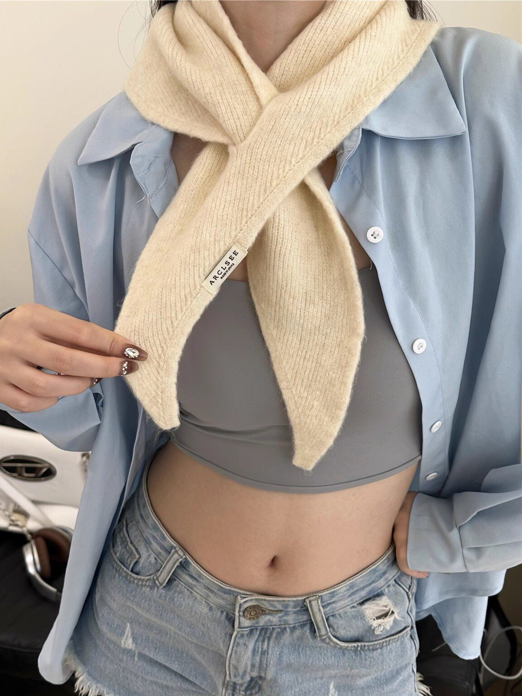 Cream pull-through scarf with tapered ends, worn view