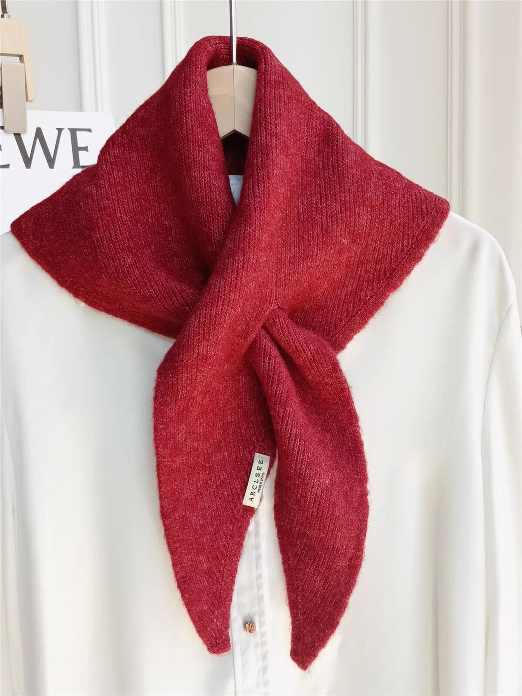 Red pull-through scarf displayed on a white shirt