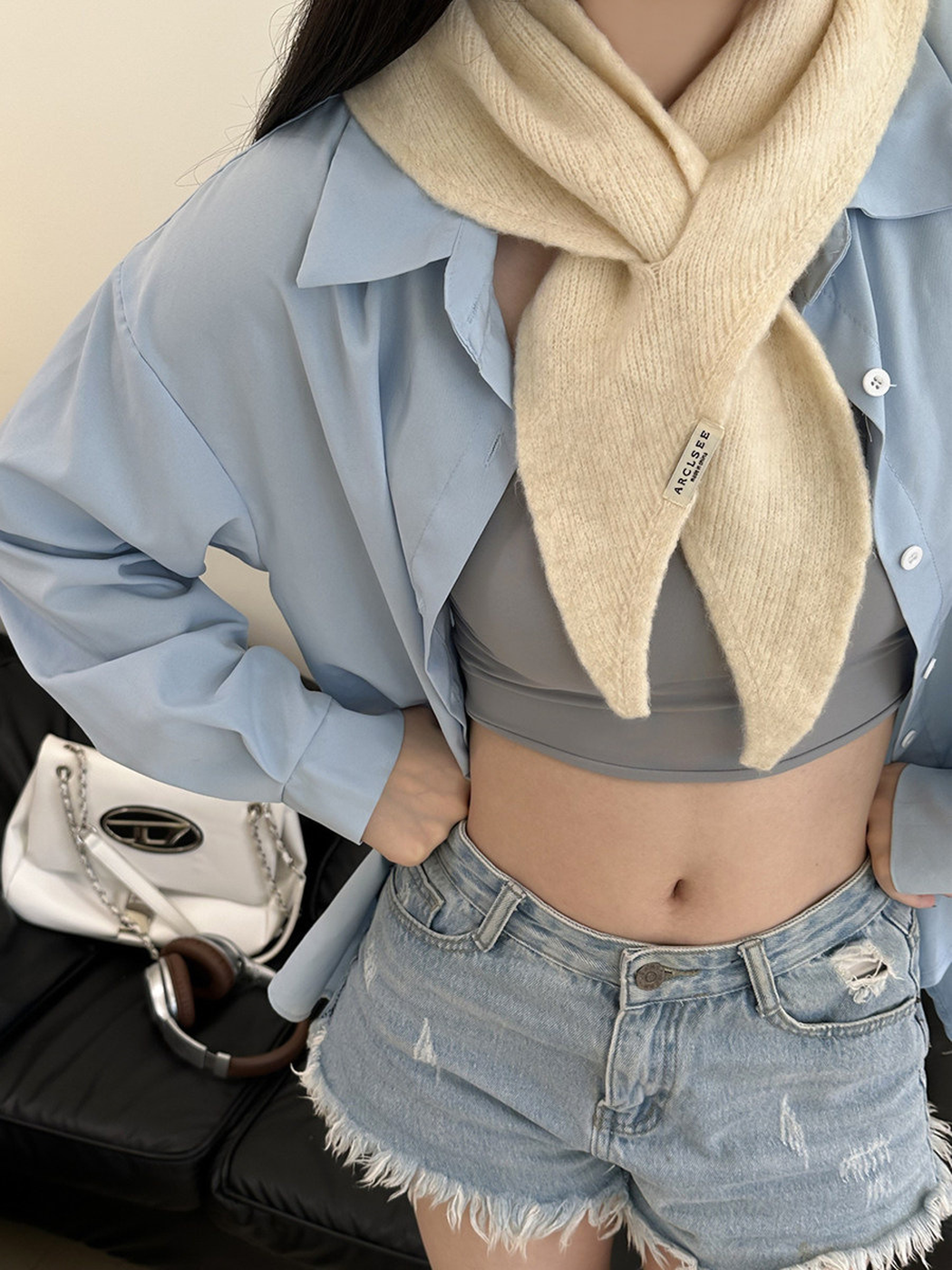 Cream pull-through scarf styled with a light blue shirt and denim shorts