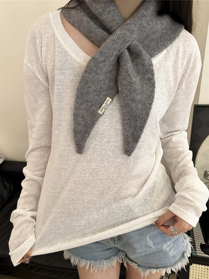 Gray pull-through scarf styled with a white long-sleeve top