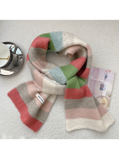 Ivory, pink, coral, green and light blue striped scarf arranged in a loose knot