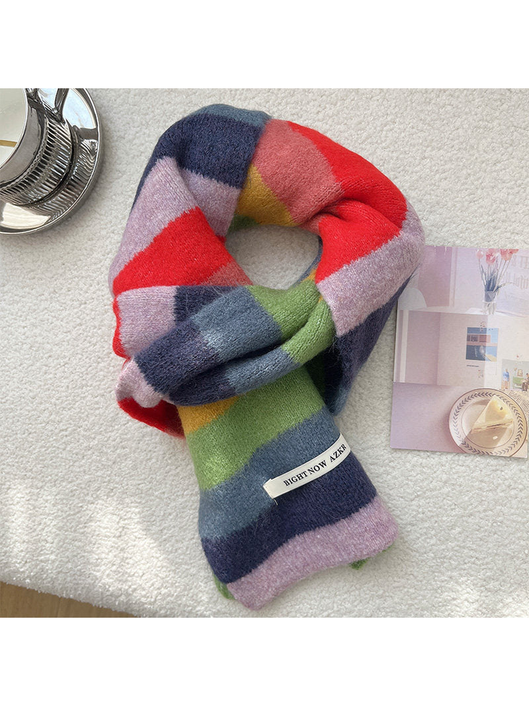 Red, coral, lavender, navy, green and mustard striped scarf arranged in a knot