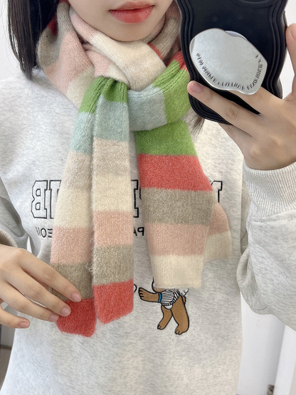 Ivory, pink, coral, green and light blue striped scarf worn around the neck