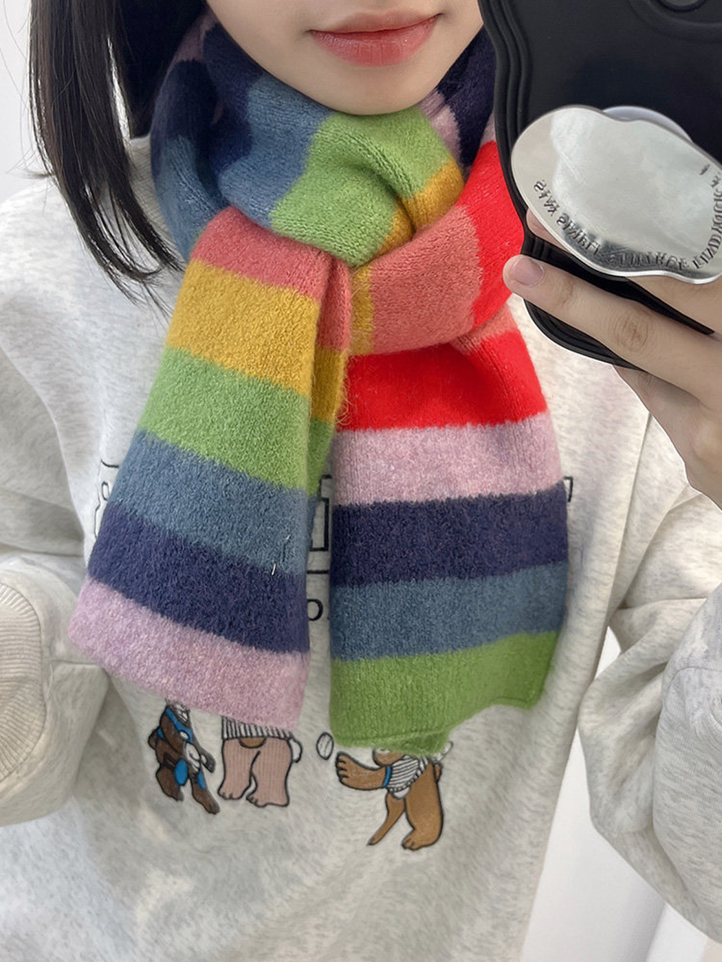 Bright red, navy, green and lavender striped scarf worn around the neck