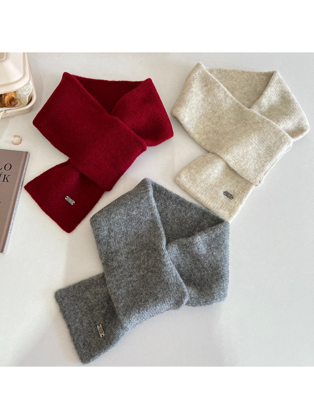Red, ivory and dark gray narrow scarves arranged in crossed styling configurations