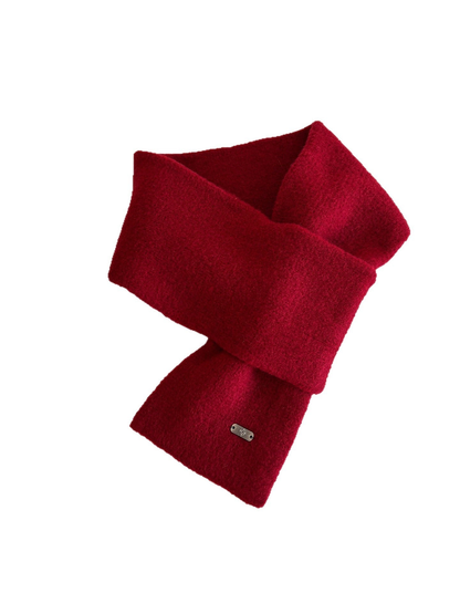Red narrow scarf arranged in a crossed loop on a white background