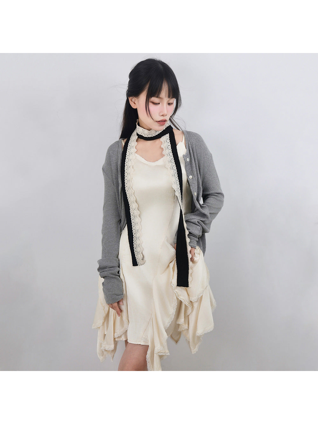 Black narrow scarf with scalloped lace trim styled with a layered dress