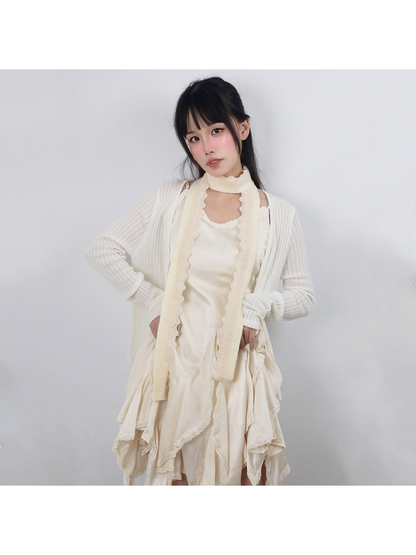 Pale yellow narrow scarf with scalloped lace trim styled over a cream dress
