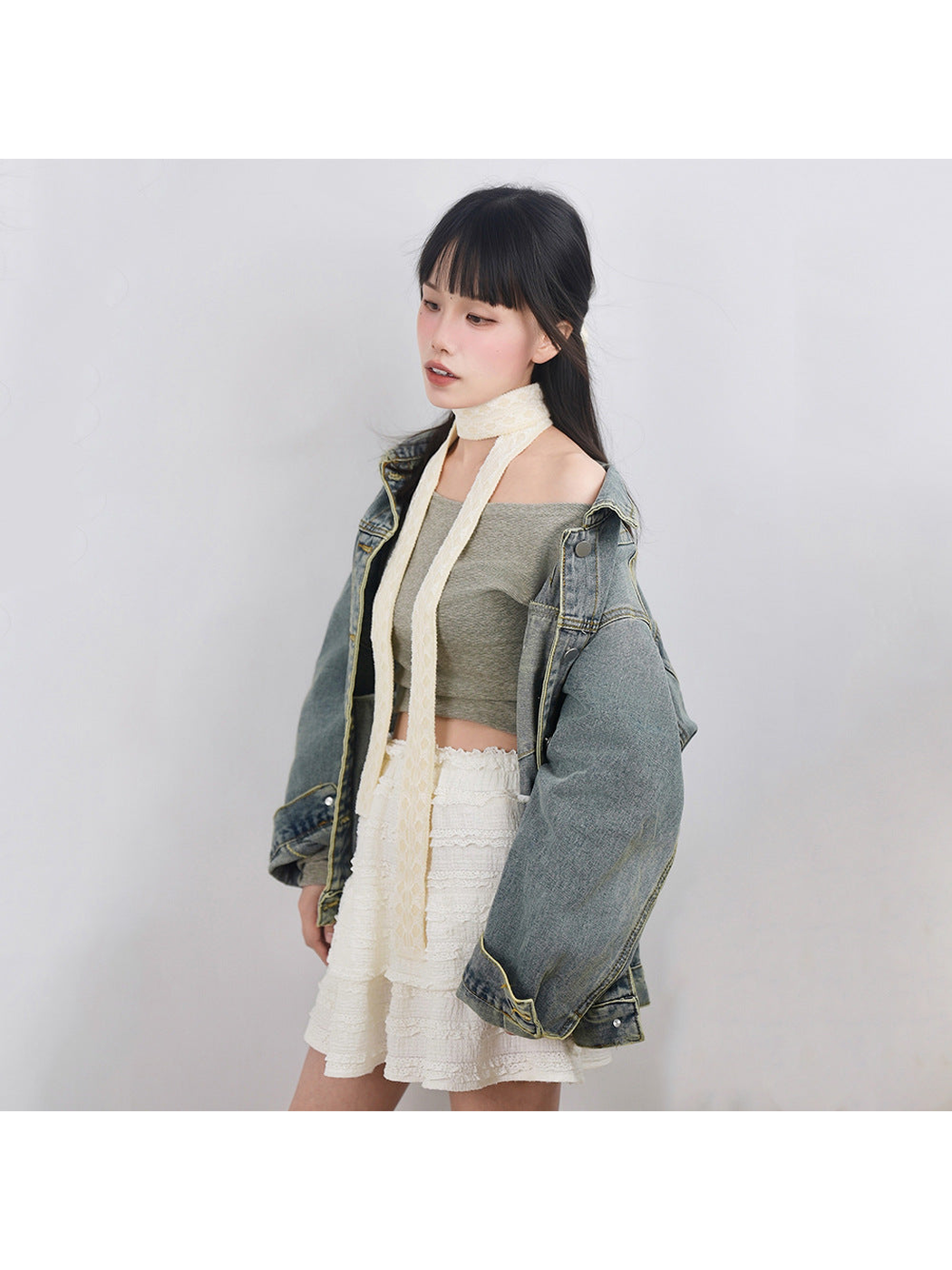 Cream lace-trim skinny scarf styled with a denim jacket