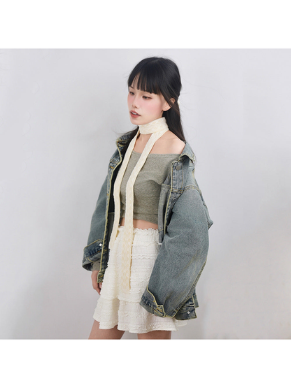 Cream lace-trim skinny scarf styled with a denim jacket