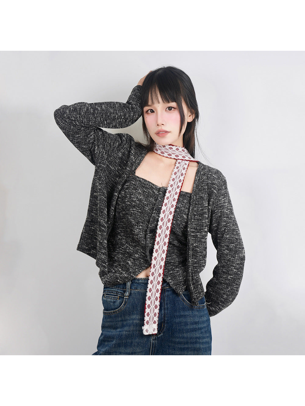 Red lace-trim skinny scarf styled with a gray cardigan and jeans