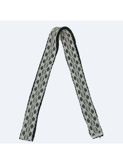 Black lace-trim skinny scarf in a full-length folded view