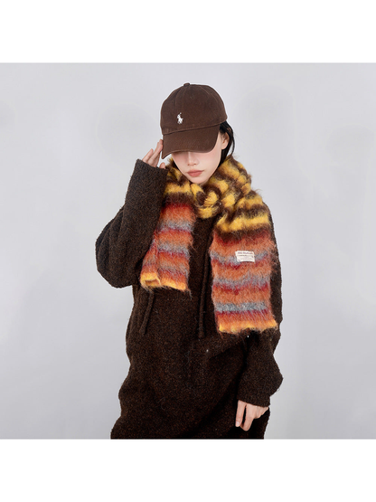 Yellow, brown and orange striped fuzzy scarf worn in a front view