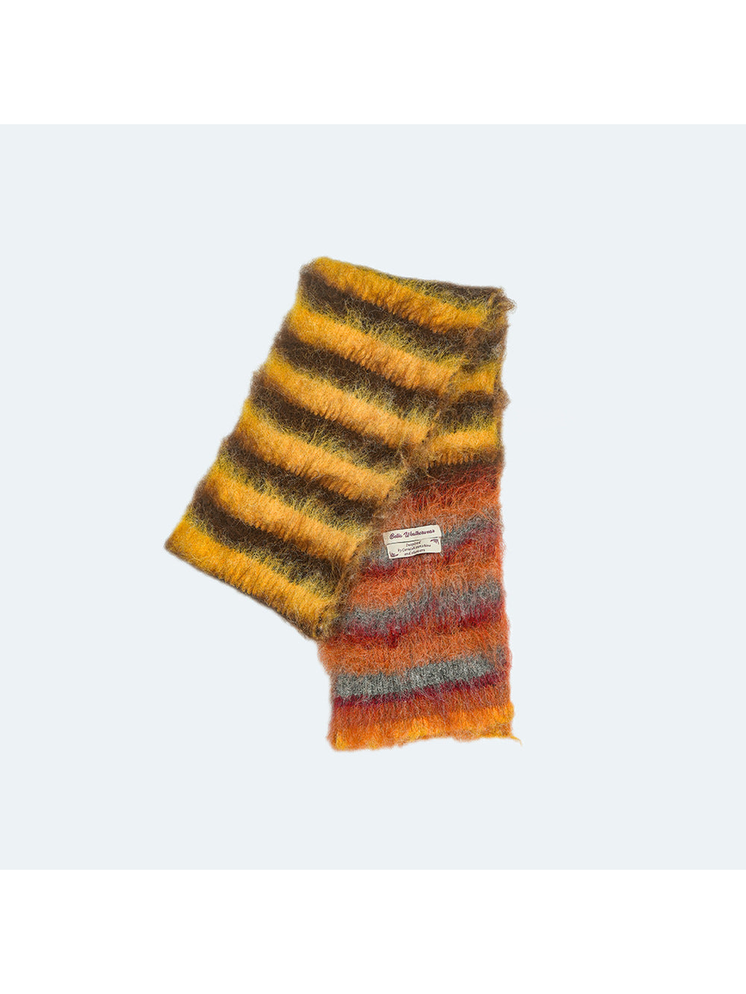 Yellow, brown and orange striped fuzzy scarf displayed folded