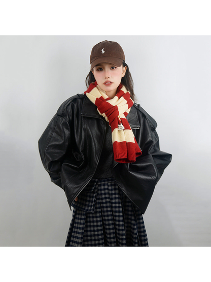 Red and cream striped scarf tied at the neck with both ends visible