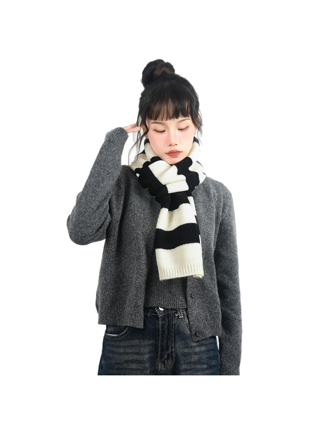 Black and cream striped scarf tied at the neck with a gray cardigan