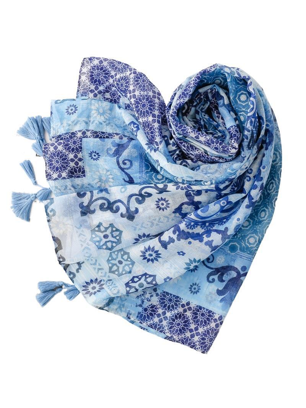 Blue patchwork-pattern scarf loosely rolled to show its drape and tassels