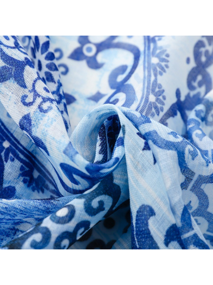 Close-up of the scarf's fine lightly sheer weave across overlapping folds
