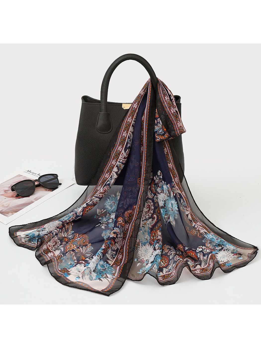 Navy sheer scarf with pale floral motifs and an ornamental border