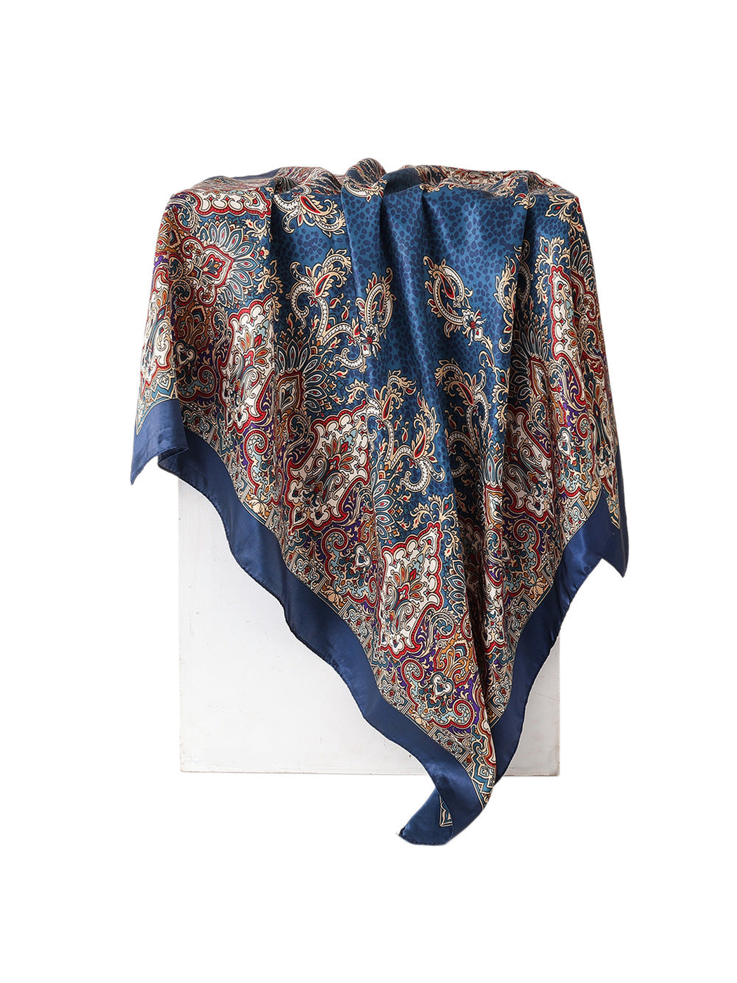Navy square scarf with cream, red and tan paisley print, draped view
