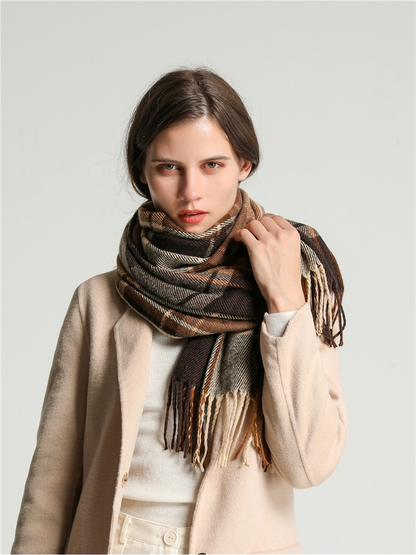 Brown, cream and gray plaid scarf wrapped closely around the neck while being adjusted by hand