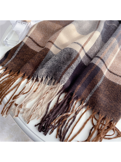 Close-up of coordinating brown, cream and gray twisted fringe along the plaid scarf edge