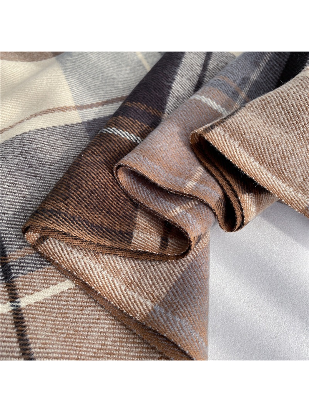 Close-up of the plaid scarf folds with brushed texture and fine diagonal ribs