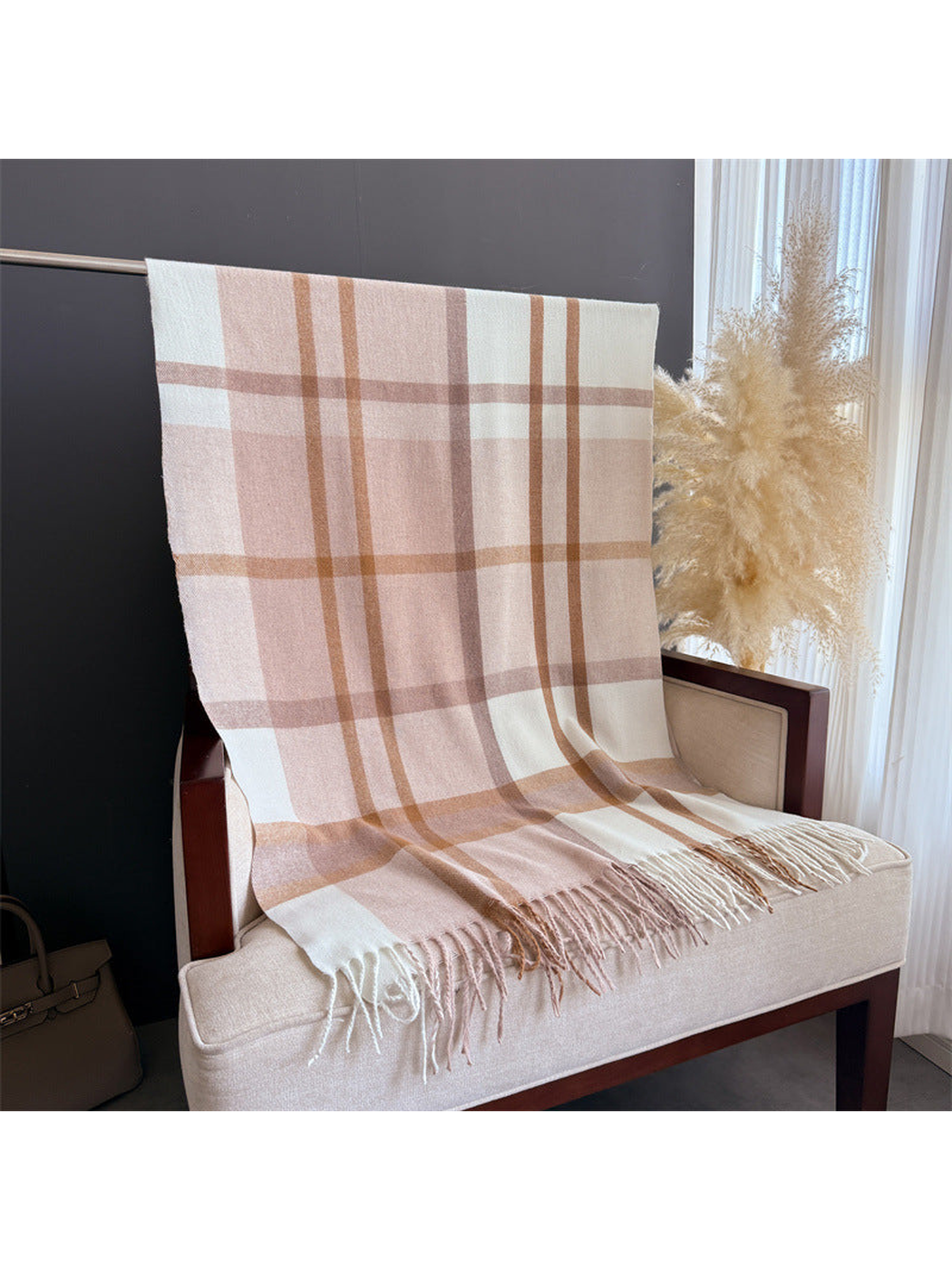 Blush and cream plaid scarf displayed at full length with fringed ends