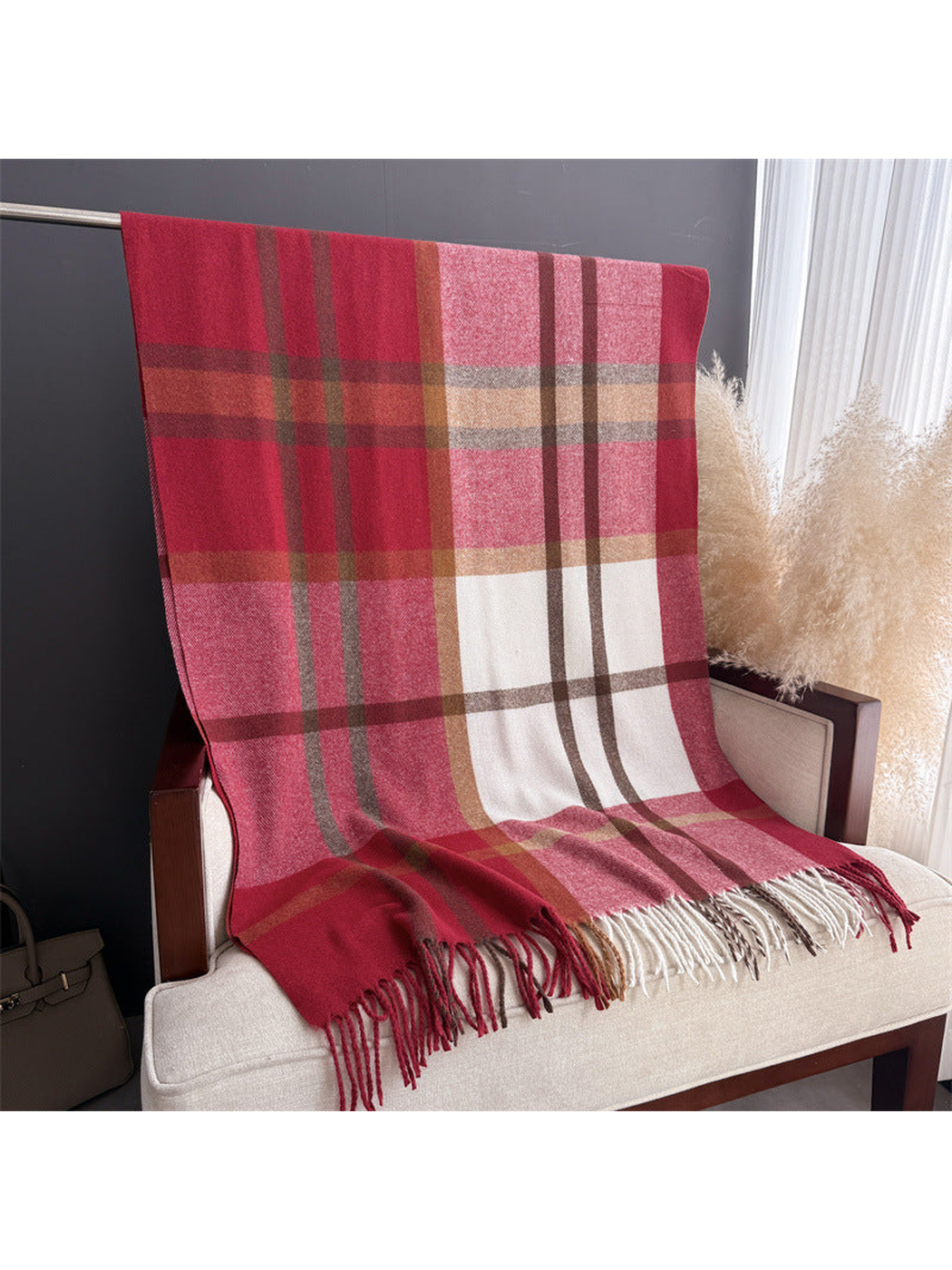 Red plaid scarf displayed at full length with multicolor fringe