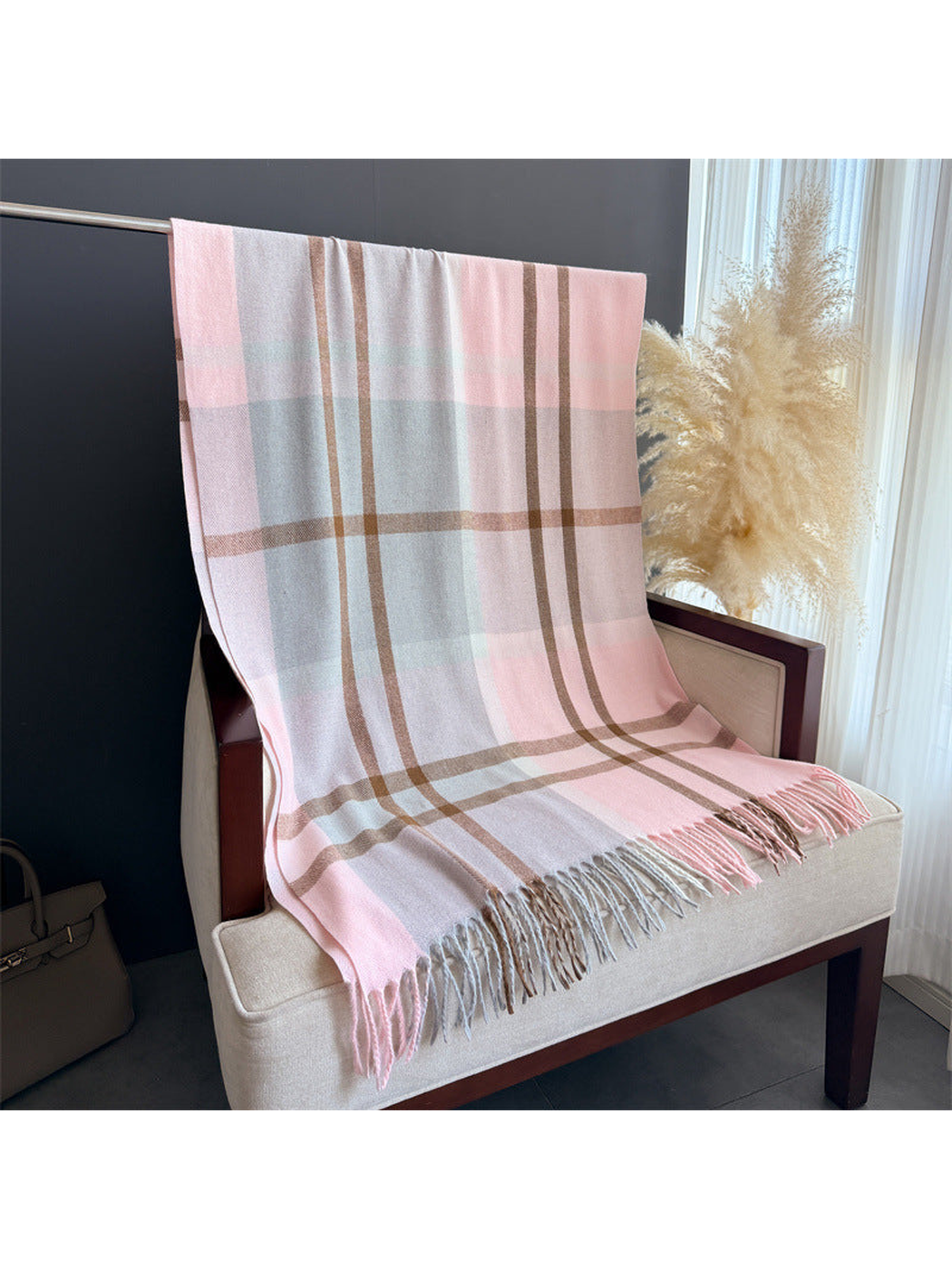 Pink and gray plaid scarf displayed at full length with fringed ends