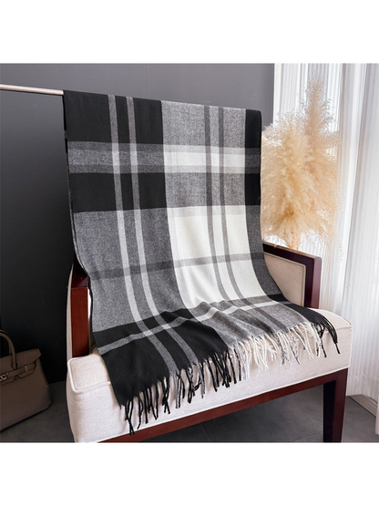 Black, gray and white plaid scarf displayed at full length with fringe