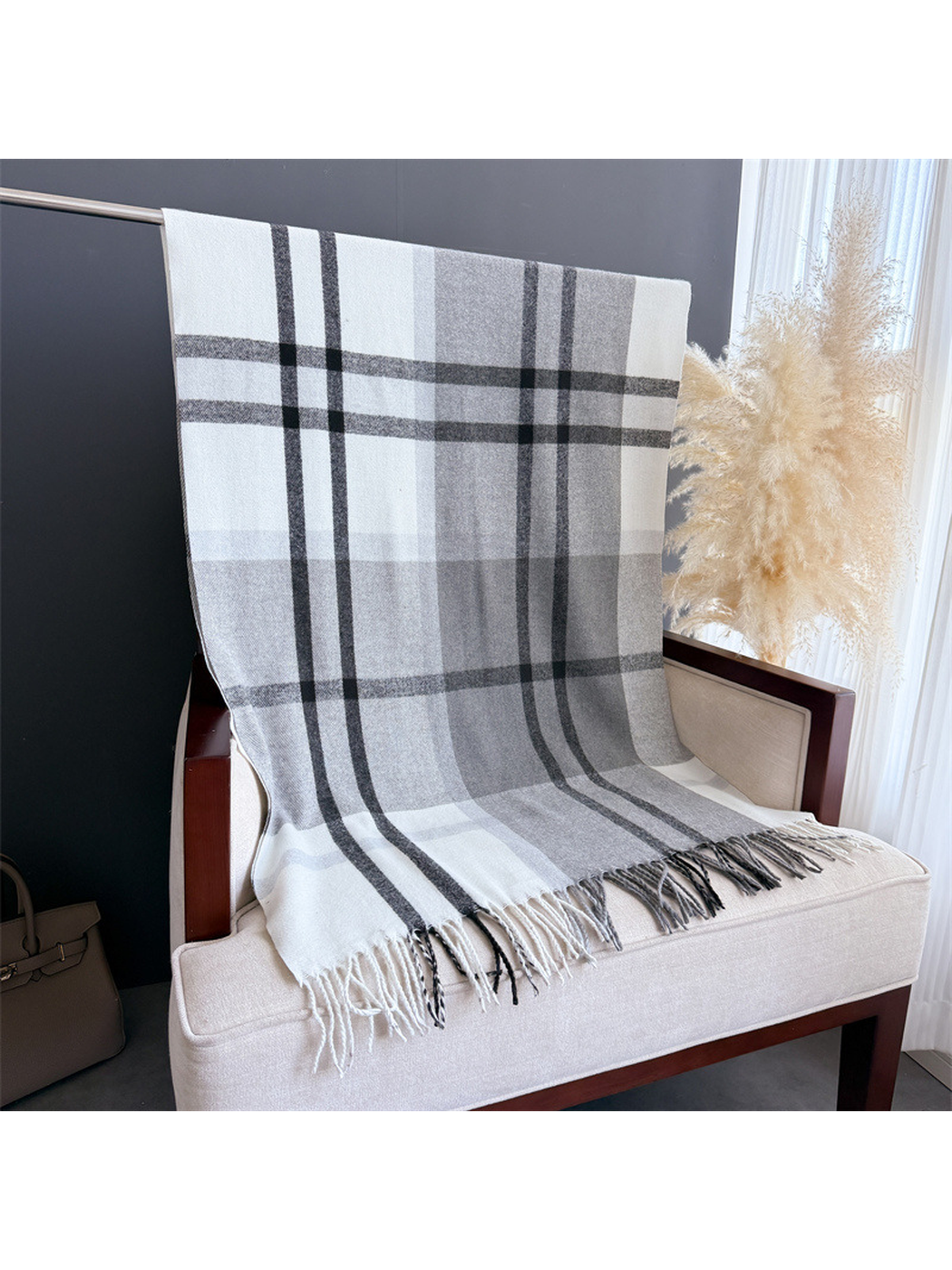 Gray and white plaid scarf displayed at full length with fringed ends