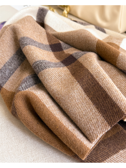 Close-up of the brown plaid scarf folded to show its woven texture and color bands