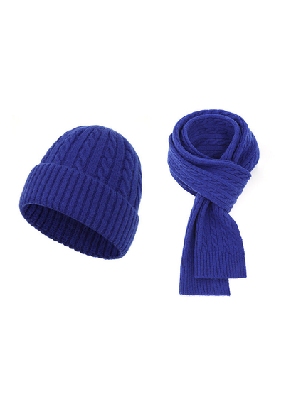 Bright blue cable-knit hat and scarf set on a white background