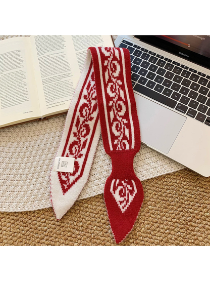 Red paisley pull-through scarf laid flat to show its pointed ends