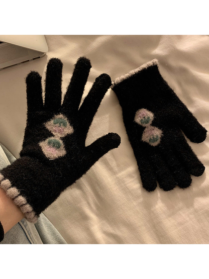 Black fuzzy gloves with stacked floral motifs and contrasting cuff trim