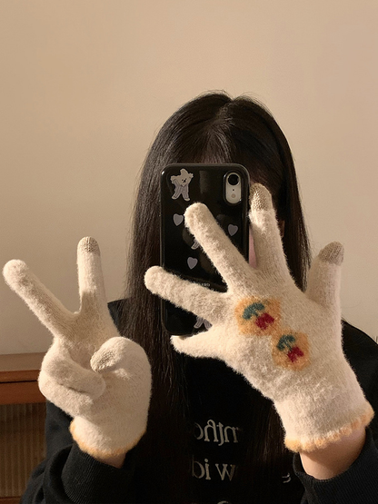 Cream fuzzy floral gloves worn with one hand making a peace sign