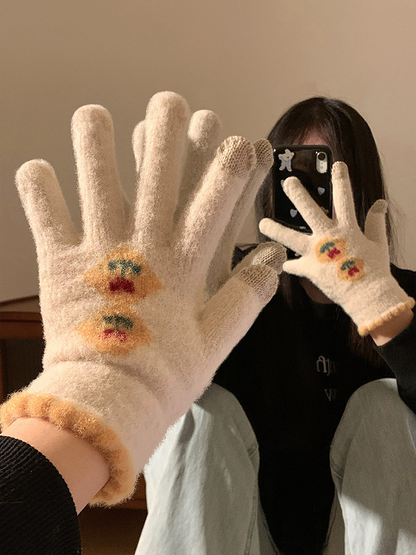 Close view of cream fuzzy floral gloves worn in a mirror scene
