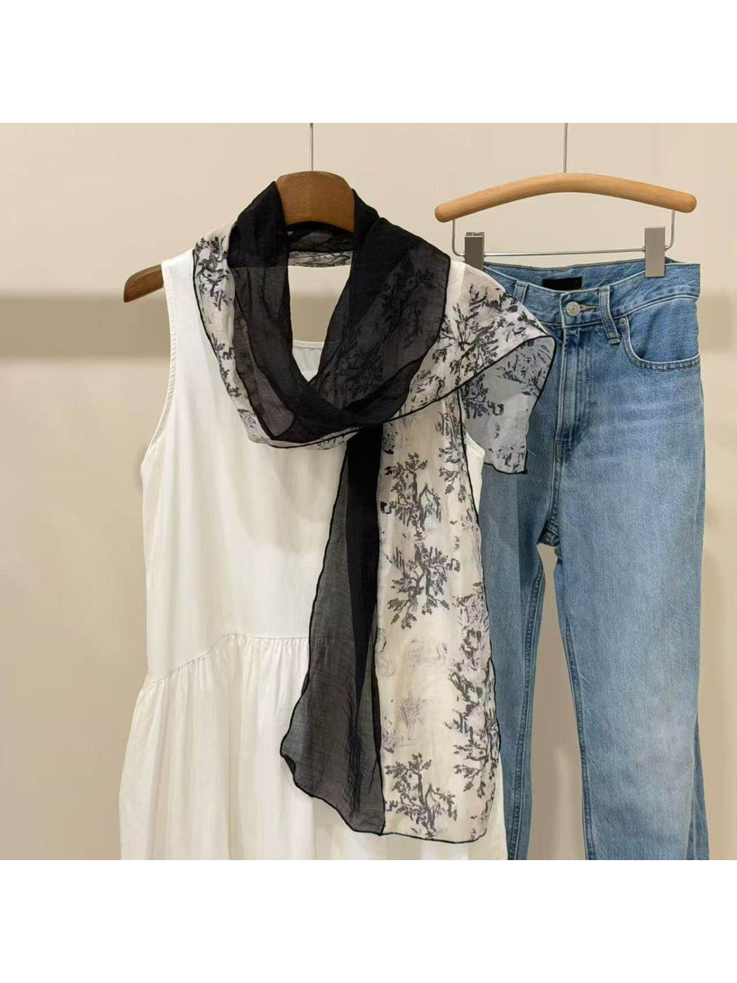 Black sheer scarf with contrasting botanical-print panels, draped view